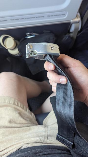 an airplane seatbelt with the buckle now facing the correct direction