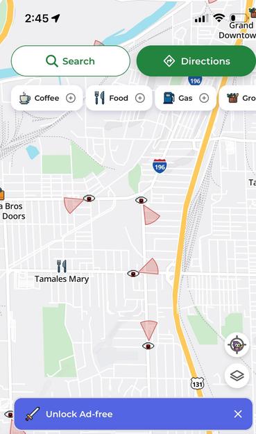A Mapquest app screen of downtown Grand Rapids Michigan, showing surveillance street cameras as eyes, with red cones showing their field of vision.