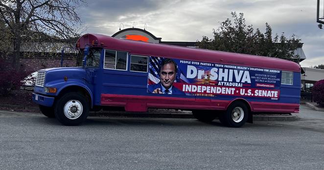 Picture of an ancient “Partridge family” style school bus painted blue with red highlights and with a bunch of gibberish advertising the senate run of serial fabulist Dr Shiva

Good luck* to him, because it’s not gonna do him any good when he gets blown the fuck out in the election.

I’ve blurred the restaurant that he’s parked next-door to, because it’s one of my favorite restaurants and I don’t want to smear their names by even being in close proximity to this. (it’s parked in the parking lot next-door) good for you I’d think

*not really
