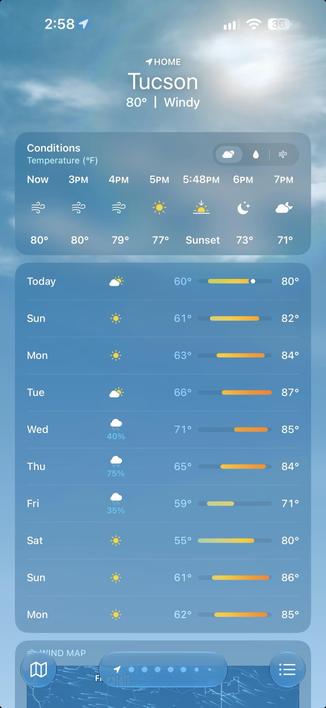 A weather app interface for Tucson showing current conditions with temperatures in Fahrenheit. The top section shows "HOME" and location as "Tucson," with a temperature of 80°F and wind conditions noted. A timeline from now to sunset at 5:48 PM is displayed, with icons representing weather conditions like clouds, sun, and moon phases. Below this, daily forecasts for the week are listed, showing high temperatures ranging from 61°F on Sunday to 71°F on Wednesday, with low temperatures starting at 55°F on Saturday. Each day's forecast includes a percentage chance of precipitation and icons indicating sunny or cloudy skies. The background is a gradient blue sky image. At the bottom, there are navigation icons for wind map and menu options.