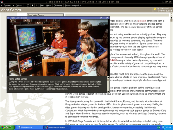 The Encarta article for Video Games. It includes a staged photograph of a mother and her two children playing Mario Paint on the Super Nintendo Entertainment System.