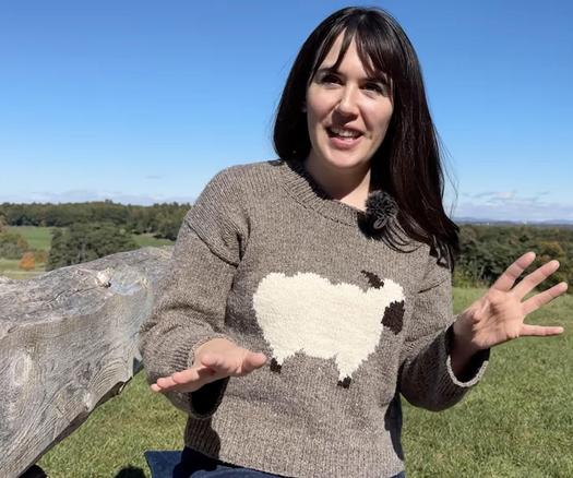 Tamara in a recent sweater she knitted using undyed sheep's wool, it is a grey with white sheep that has darker wool for hooves, face and ears.