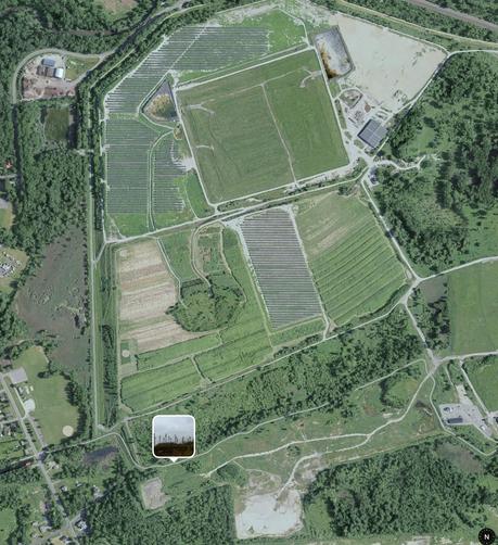 Apple map showing the area I took photo (thumbnail where I was standing), to my left (top of image) is what looks like old landfill that has been covered by arrays of solar panels in a few sections. To my right, bottom of image, there's a white-ish patch of bare dirt which I think is where the poles in photo were at (i.e. they are relatively recent addition). Google's satellite view doesn't show the solar panels, so they seem to be relatively recent as well.