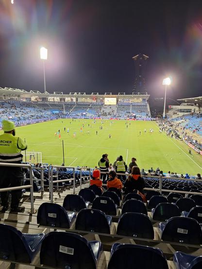 A picture of Saputo Stadium up high. Green putch, lots of empty blue seats.