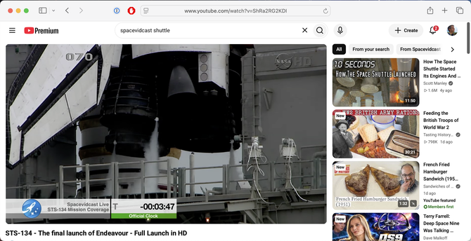 A youtube browser window in standard mode, narrowed vertically. The video (of a Space Shuttle launch) is in about two-thirds of the available space, and the rest is taken up by ads for other videos.