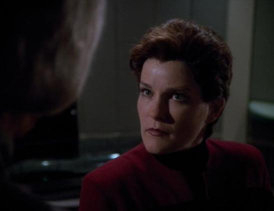An evil looking version of Janeway glares at someone.