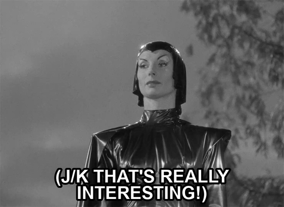 screenshot from the film Devil Girl From Mars showing a serious woman wearing a black leather suit, cape, and cowl. Text reads: "(j/k that's really interesting!)"