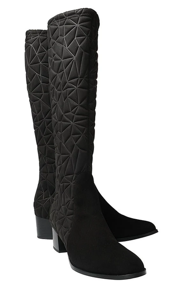 A pair of heeled long black boots, the legs have a geometric pattern sewn into the fabric.